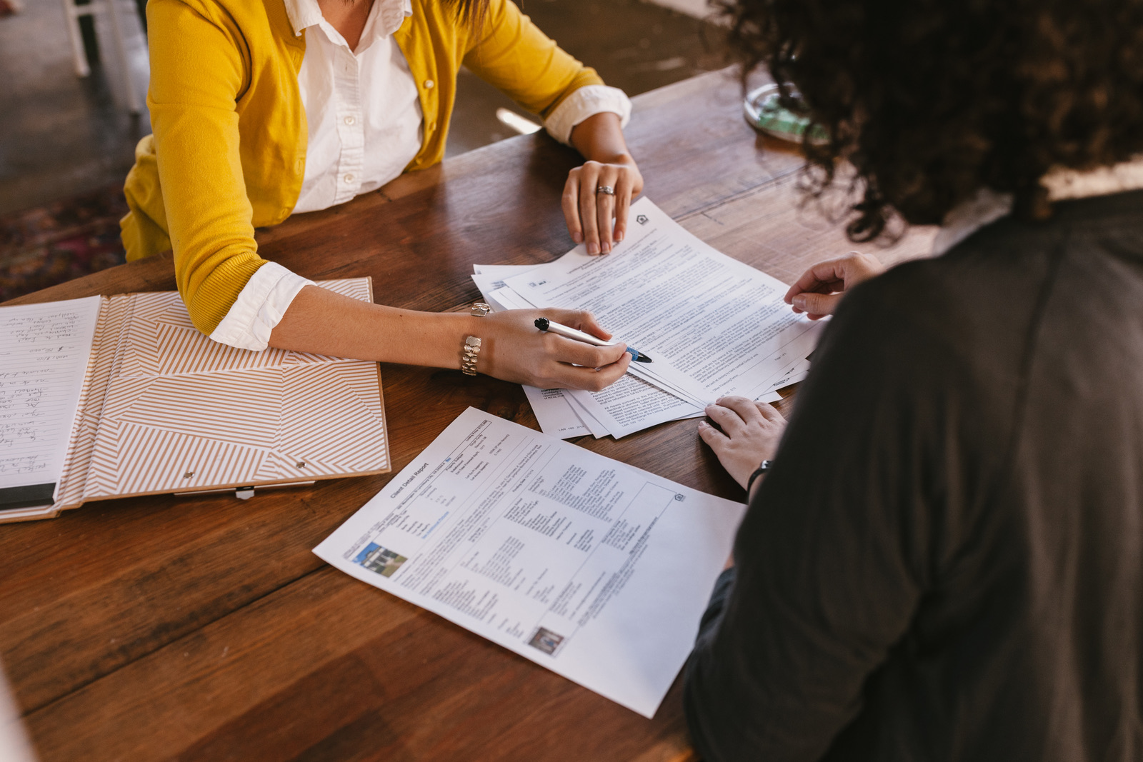 A REALTOR® walking a client through listing paperwork